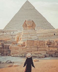 a woman standing in front of the great pyramid