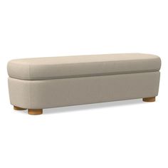 an upholstered bench with wooden legs on a white background and no people around it