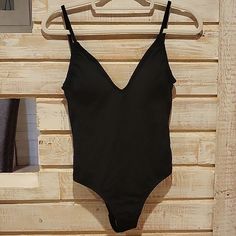 Simple And Classy Black One Piece Swimsuit By Kona Sol. Lightly Lined With Great Support. Adjustable Straps, Size Small (4-6). Chic Black Seamless Leotard, Summer Black Backless Leotard, Backless Black Leotard For Summer, Black Backless Summer Leotard, Black Backless Leotard For Summer, Black Backless Leotard With Lined Body, Black One-piece Lined Leotard, Black Beachwear Bodysuit With Built-in Bra, Black Summer Leotard With Lined Body