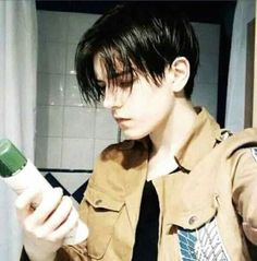 a young man holding a hair dryer in his hand