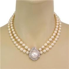 "This is a beautiful Estate necklace; the pendant features a fancy octagonal 14k white gold frame set with 75 points sparkling diamonds and the center of the frame has a large 17.5mm Mabe pearl. Attached to the pendant is a double strand rich cream cultured pearls 7.4-8mm. The end of the double strand has screw stems and can screw in and out from the side of the pendant. The back of the pendant also has a fixed hook bail.    Material:  14k white gold Diamond: 75 points Color: H-I  Clarity: VS1 P Mabe Pearl, Diamond Chain, Frame Set, Sparkle Diamonds, Cultured Pearls, Pearl Pendant, White Gold Diamonds, Gold Frame, Link Bracelets