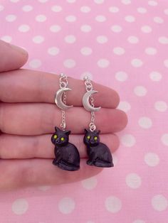 Hello and welcome to my listing for a pair of Hand-Painted Black Cat Moon Dangle Earrings!  These festive dangle earrings are handmade and feature a hand-painted resin cat charm, metal moon charm, and metal studs with push back closures. 🎃👻Please avoid wearing this item while showering, sleeping, swimming or exercising to avoid damage. Store jewelry in an airtight plastic bag to prevent tarnish and discoloration. Always treat jewelry gently to prolong its lifespan. 🎃👻Customization: If you re Cat Moon, Cat Charm, Colorful Jewelry, Moon Charm, Sensitive Ears, Plastic Bag, Black Cat, Jewelry Earrings Dangle, Dangle Earrings