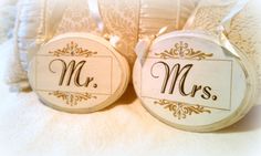 two wooden tags with the word mr and mrs printed on them sitting next to each other