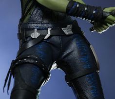 the action figure is dressed in black and blue leathers with silver accents on his arms