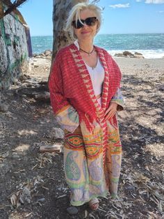 One of a kind sustainable jacket made with vintage kantha cotton.  One size only fits upto 2XL Bohemian Patchwork Beach Outerwear, Handmade Long Bohemian Kimono, Red Bohemian Kimono For Fall, Red Bohemian Outerwear For Festival, Red Bohemian Festival Outerwear, Red Long Bohemian Outerwear, Long Red Bohemian Outerwear, Winter Bohemian Patchwork Kimono, Bohemian Winter Patchwork Kimono