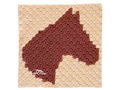 a crocheted afghan with a horse on it's back end and the words,