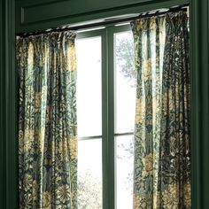 an open window with curtains in front of it