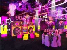 a party room decorated in neon colors with disco lights and decorations on the walls,