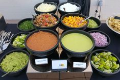 a table topped with bowls filled with different types of food and condiments on top of it