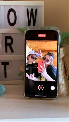 a cell phone sitting on top of a table next to a sign that says slow motion