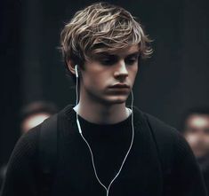 a young man with headphones on his ears