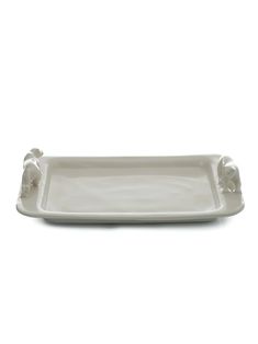 a white tray with two elephants on it