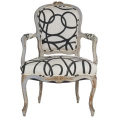 an old chair with black and white designs on it