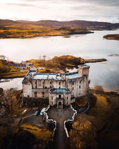 an aerial view of a castle in the middle of a lake