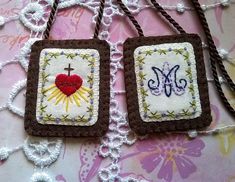 two small handmade tags with cross and heart on them