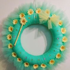 a green wreath with yellow daisies on it