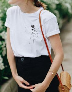 This super cute heart snap finger tee has a very soft, loose fit! So comfy and cool for a casual outfit. Tie on the side for a cropped look and style with high waist denim bottoms. ------------------------------------------------------------------------------------------------------------------------------------------------- * 100% ring-spun cotton * 4.5 oz/y² (153 g/m²) * Pre-shrunk * Shoulder-to-shoulder taping * Quarter-turned to avoid crease down the center ---------------------------------- Casual Heart Print T-shirt With Relaxed Fit, Casual Heart Print T-shirt For Summer, Casual Relaxed Fit T-shirt With Heart Print, Trendy T-shirt With Heart Graphic For Everyday, Trendy Relaxed Fit T-shirt With Heart Print, Heart Graphic Tee For Everyday, Everyday Graphic Tee With Heart Graphic, Heart Graphic Tee For Everyday Wear, Everyday Heart Graphic Tee