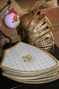 a table topped with lots of gold and white items