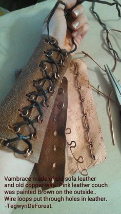 a person is working on some leather with scissors and pliers next to it are several different types of stitchers