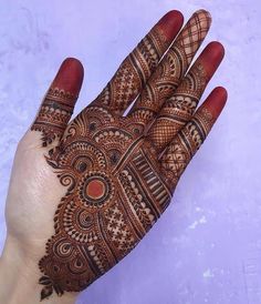 the hand is decorated with intricate designs