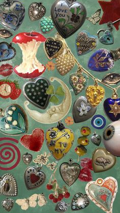 an assortment of heart shaped items on a table top, including brooches and pendants