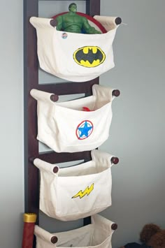 an over the door toy storage rack with batman and captain america decals on it