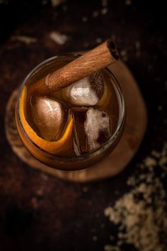 an old fashioned drink with ice and cinnamon