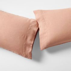 two peach colored pillows on top of each other