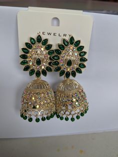 Indian style jhumka earrings. Vintage style. Costume jewellery. Green Latkans Bridal Earrings For Diwali, Green Latkan Bridal Earrings For Diwali, Green Bridal Earrings With Latkans For Diwali, Green Dangle Jhumkas For Festive Occasions, Green Bridal Earrings For Party And Festivals, Festive Green Chandelier Earrings For Party, Green Latkans Danglers For Celebration, Green Danglers With Latkans For Celebration, Green Danglers For Party And Festive Occasions