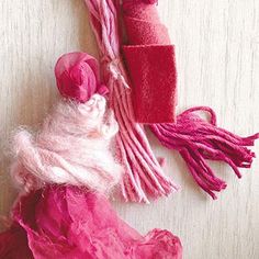 pink and red pieces of fabric sitting on top of a table