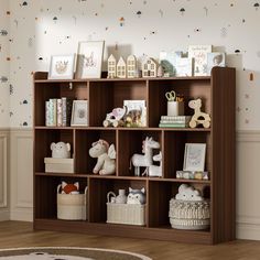 a bookshelf filled with lots of toys and stuffed animals on top of it