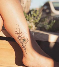 a close up of a person's foot with flowers on it