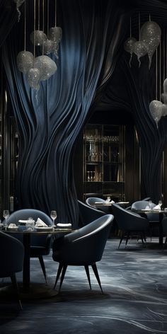 the interior of a restaurant with black walls and chandeliers