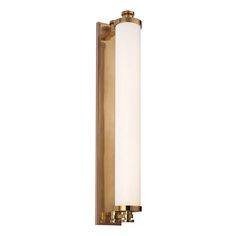 a brass wall light with a white glass shade