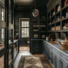 a kitchen with dark blue cabinets and an area rug