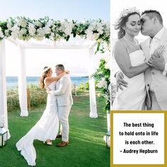 a man and woman standing next to each other in front of a white arch with flowers on it