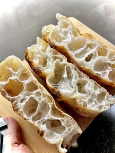 two pieces of bread sitting on top of a cutting board