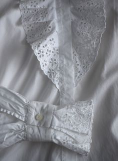 Vintage white lace women's blouse, from the 1990s era Victorian style, white blouse with a lavish ruffle lace front with eyelet floral embroidery and the same lace decorations on the cuffs. Slightly fitted body, looks great tucked into high waist jeans Material - missing tag, probably a cotton-polyester blend Size - marked 40 EU which is M. This is the vintage size, please look at measurements below to see if it will fit you: Approximate Measurements (taken when blouse lying flat, double armpit Fitted Cotton Lace Top With Broderie Anglaise, White Cotton Blouse With Lace Collar, Victorian Long Sleeve Tops For Spring, Elegant Cotton Lace Patchwork Tops, White Tops With Lace Trim And Peter Pan Collar, White Spring Tops With Lace Cuffs, Feminine White Cotton Lace Top, Elegant Cotton Lace Top With Ruffles, White Tops With Lace Cuffs For Spring