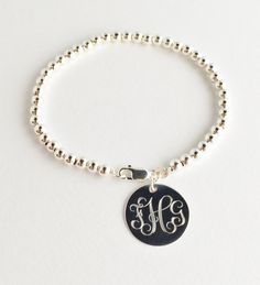 "Monogrammed Bead Bracelet Sterling silver monogrammed charm on sterling silver bead bracelet. This bracelet makes a wonderful present. Round charm can be monogrammed or engraved with a name. Great option for Bridesmaids or anyone who loves monograms and sterling silver. A classic design made to last a long time. Shown here with the popular Interlocking Monogram, other options are shown in the photos to the right Please provide initials in the order you would like them engraved, for Interlocking Weddings Gifts, Silver Bridesmaid, Monogram Bracelet, Handmade Gold Jewellery, Sterling Silver Bead Bracelet, Silver Monogram, Jewelry Bracelets Silver, Athens Ga, Silver Bead Bracelet