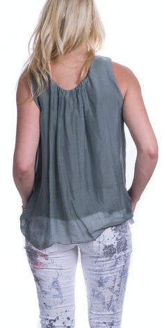 Solid, silk tank with small gathers around a wide neckline. This tank features two layers a with soft viscose jersey layer underneath. 100% Silk Exterior 95% Viscose 5% Elastin Interior One Size Fits Most Made in Italy Sleeveless Top With Gathered Neckline For Spring, Sleeveless Blouse For Layering, Layering Sleeveless Blouse, Layering Sleeveless Blouse In Any Color, Solid Sleeveless Blouse For Layering, Sleeveless Blouse Tops For Layering, Casual Sleeveless Modal Tops, Chic Summer Top With Gathered Neckline, Tank Camisole For Layering