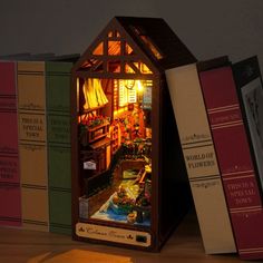 a miniature house made out of books on a table