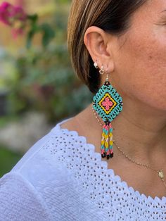 These earrings are part of the art and traditions of the highland Mayan communities in Chiapas, Mexico. These earrings look great for any age and for any occasion. Your purchase is will help the indigenous artisans of Chiapas. The earrings are lightweight and add a pop of color to any outfit. Easy to wear from day and transition into night. We love how fun these are. Closure: Ear Wire Material: Beads, synthetic thread, and stainless steel ear threaders Made in Mexico Traditional Adjustable Handwoven Beaded Earrings, Traditional Handwoven Drop Earrings, Traditional Turquoise Beaded Earrings As Gift, Traditional Turquoise Beaded Earrings For Festivals, Traditional Turquoise Beaded Earrings For Gifts, Unique Handwoven Festival Earrings, Unique Handwoven Earrings For Festivals, Traditional Round Bead Earrings For Festivals, Traditional Turquoise Beaded Earrings