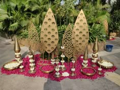 a table topped with lots of different types of vases and bowls filled with flowers