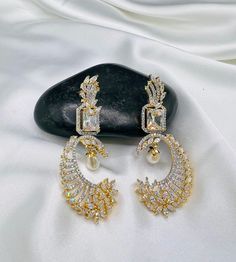 If you love bling and want to make a bold statement, this pair of dangling earrings are perfect for you! 【Exquisite Craftsmanship】 Gorgeous  American Diamond Earrings to be your perfect mate for the evening! Sparkle in this luxurious pair of long silver golden CZ earrings with white pearl and stone which are crafted to perfection.  【Lightweight and Comfortable】 You can wear these long dangly earrings for a long time without feeling the pressure of them weighing your earlobe down even for sensitive ears; The design is simple and generous, equally gorgeous for both casual and dressy occasions. These earrings are also perfect for bridesmaids or brides. 【Versatile Use】 These sparkle earrings are suitable for special occasions such as weddings, Mother's Day, Valentine's Day, Balls, Proms, Gradu Pearl Drop Cubic Zirconia Earrings For Party, Elegant White Earrings For Wedding Reception, Elegant Drop Earrings For Wedding Reception, White Crystal Earrings With Elegant Design For Party, Party Pearl Drop Chandelier Earrings In Cubic Zirconia, Party Chandelier Earrings With Pearl Drop And Cubic Zirconia, White Elegant Earrings For Party, Elegant Design Party Danglers Drop Earrings, Elegant Party Danglers Drop Earrings