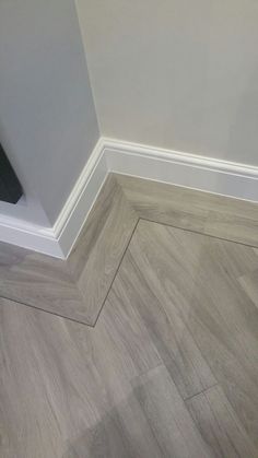 the corner of a room with wood flooring