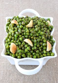 green peas with almonds in a white bowl