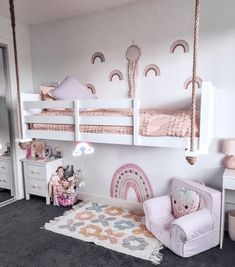 a child's bedroom with two bunk beds and a chair