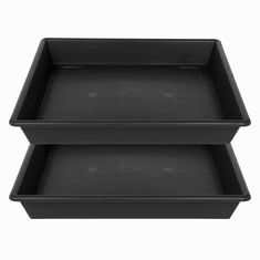 two black plastic trays sitting side by side on top of each other in front of a white background