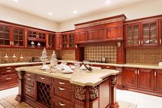 a large kitchen with wooden cabinets and marble counter tops, along with a center island