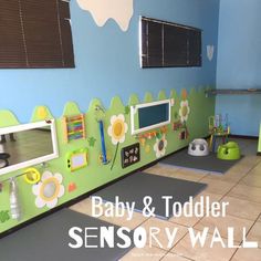 a child's playroom with green walls and toys